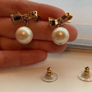 Kate Spade earrings. Love Notes bow with dangling faux pearl. Gold tone. Studs